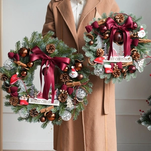 Burgundy bell wreath and Christmas tree ornaments with pine needles and wood signs