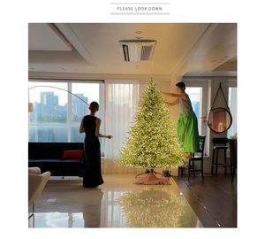 Lush LED Christmas tree with warm white lights and a red fringe skirt for festive decor