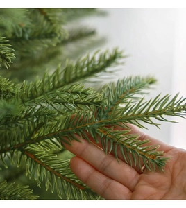 Detailed close-up of lush PE artificial Christmas tree needles with natural brown branches