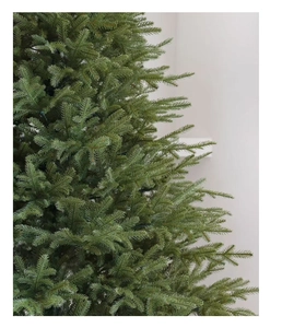 Close-up of high-density green PE pine needles on a realistic artificial Christmas tree