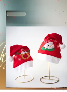 Close-up of Christmas hats with plush reindeer and snowman embroidery for festive holiday decor