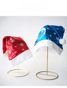 Close-up of shiny red and blue snowflake Christmas hats with white plush fur details
