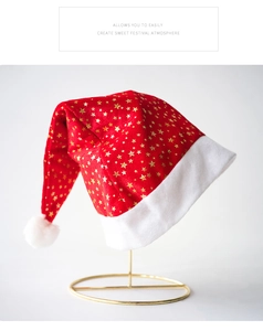 Close-up of velvet Christmas hat with gold stars on white plush trim and display stand