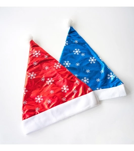Detail of red and blue Christmas hats with silver snowflake patterns and white faux fur trim