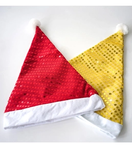 Detail of red and yellow sequined Christmas hats with white plush trim and pom-poms