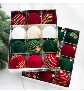 Close-up of velvet Christmas ornaments with gold glitter patterns in a snowflake gift box