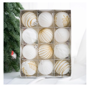 Detailed view of twelve white Christmas balls with gold patterns and textures in a box
