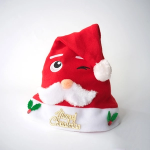 Classic plush Santa Christmas hat with embroidered face and golden Merry Christmas charm