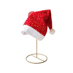 Plush Christmas hat with gold stars and white faux fur trim on a display stand