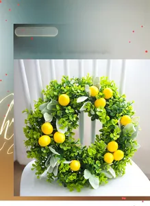 Close-up of artificial lemon wreath with green leaves and yellow fruits on a chair