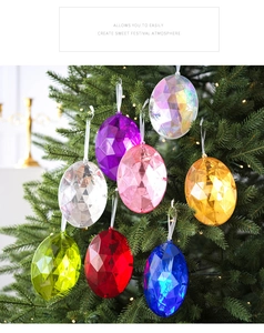 Primer plano de adornos de gemas acrílicas coloridas colgados en un árbol de Navidad