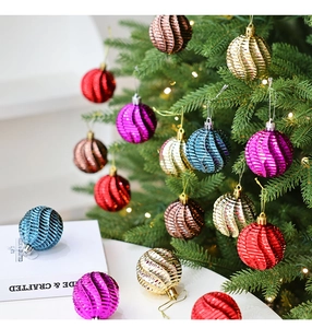 Détail de boules de Noël de 6cm à texture spirale suspendues sur un sapin de fête