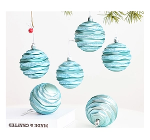 Detail of 8cm light blue Christmas balls with glitter wave texture on pine branches