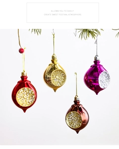 Detailweergave van kerstballen in druppelvorm met glitter op een dennenboom
