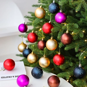 Bolas de Navidad multicolores con textura de copos de nieve en ramas de árbol festivo