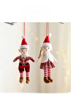 Close-up of knit Christmas elf ornaments with soft plush details and red hanging strings