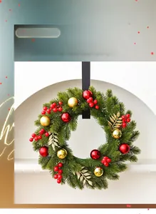 Close-up of 40cm green Christmas wreath with red berries, gold ornaments, and black ribbon