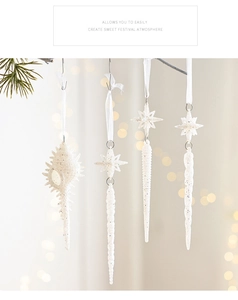 White glitter Christmas ornaments featuring seashell and star designs hanging on pine