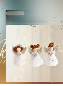 Detailed view of three plush angel ornaments with sequin mesh skirts on a branch