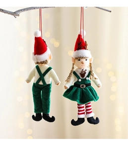 Close-up of plush Christmas elf ornaments with antlers hanging on a natural tree branch