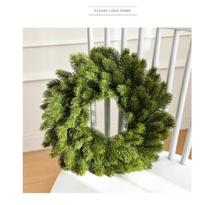 Detail of 40cm dense green artificial pine Christmas wreath on a white wooden chair