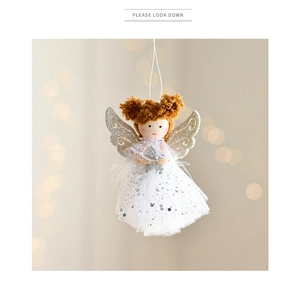 Close-up of plush angel doll ornament with white lace dress and silver sequin wings