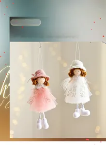 Close-up of plush angel doll ornaments with lace skirts and feathered wings for Christmas