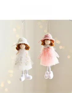 Detail of plush Christmas angel ornaments in pink and white tulle skirts and knit hats