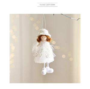 Close-up of Christmas angel doll pendant with white sequin mesh skirt and feather details