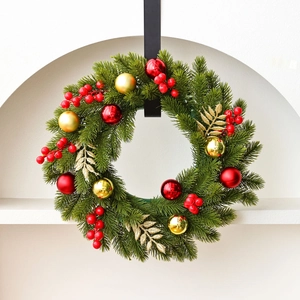 Classic Christmas pine needle wreath with red and gold baubles on a white background