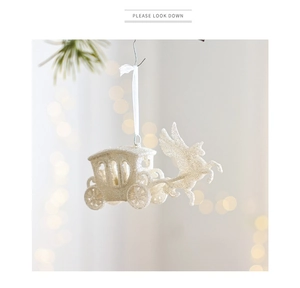 Close-up of a glittery white Pegasus pumpkin carriage hanging ornament for Christmas decor