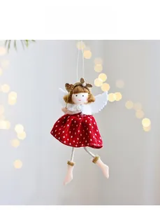 Detail of Christmas angel plush pendant with red polka dot skirt and golden magic wand