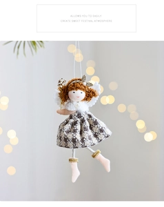 Close-up of plush Christmas angel doll with houndstooth dress and golden wings