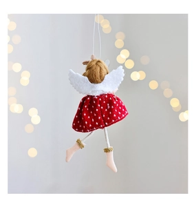 Detail of plush Christmas angel doll with white wings and red polka dot dress for tree decor