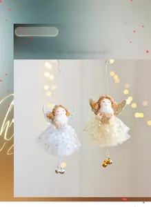 Detail of Christmas angel tree topper with sequin mesh skirt and festive bells
