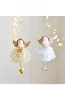 Detailed view of Christmas angel ornaments with gold and white sequins and bells
