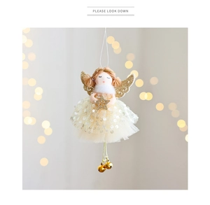Detail of Christmas angel tree topper featuring sequins gauze skirt and golden bells
