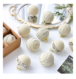 Detail of cream velvet Christmas balls with silver sequins and beads for tree decor
