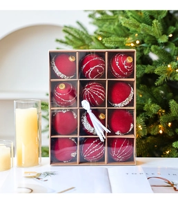 Detail of twelve burgundy velvet Christmas balls with silver glitter in craft gift box