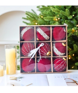 Nine burgundy velvet Christmas balls with silver sequins in a craft box display
