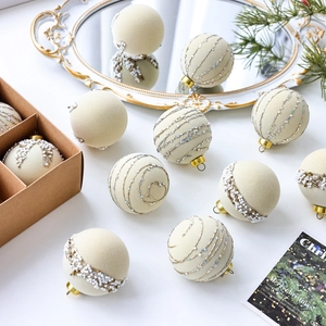 Velvet cream Christmas ball ornaments with silver glitter spirals and gold hanging loops