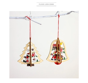 Detailed view of 3D wooden Christmas tree and bell ornaments with festive painted motifs