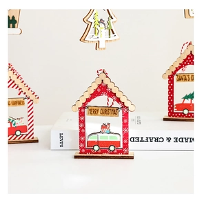 Detail of wooden 3D Christmas house ornaments with festive snowman and tree figurines