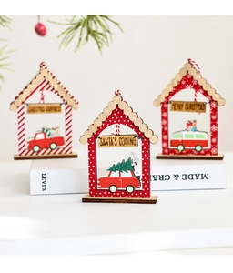 Detailed view of three red Christmas wooden house pendants with miniature holiday vehicles