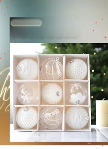 Set of 9 white Christmas baubles with snowflake and textured designs in a gift box