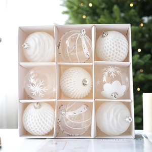 Set of 9 white Christmas baubles with glitter snowflake and swirl textures in a box