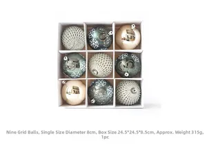 Detail of green and gold Christmas ball ornaments with glitter snowflakes in a white box