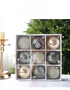 Detailed view of nine green and silver Christmas ball ornaments in a clear gift box