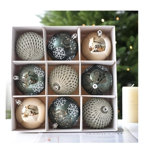 Detail of emerald green and silver glitter snowflake Christmas ornaments in 9-grid box