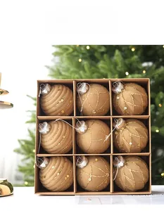 Detailed set of 9 champagne gold Christmas balls with glitter and embossed textures in a gift box